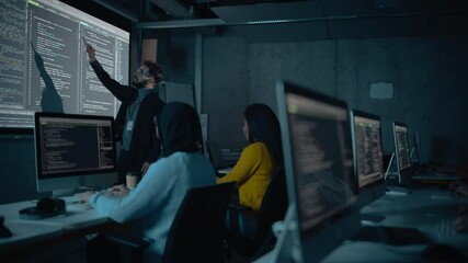 Fototapete - Teacher Giving Computer Science Lecture to Diverse Multiethnic Group of Female and Male Students in Dark College Room. Projecting Slideshow with Programming Code. Explaining Information Technology.