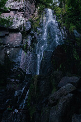 Sticker - Mesmerizing view of the waterfall of Niedeck with a cascade of water and green trees, France