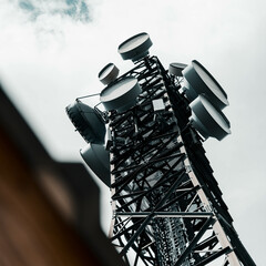 Low angle of a  metal communication tower with a light sky