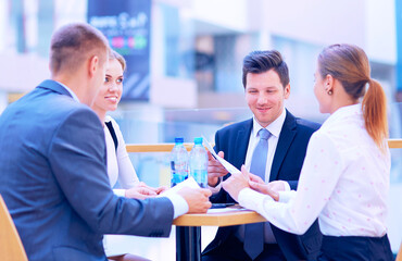 Wall Mural - Group of happy young business people in a meeting at office