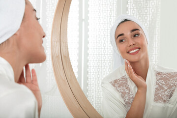 Poster - Beautiful young woman with perfect skin near mirror in bathroom. Facial wash