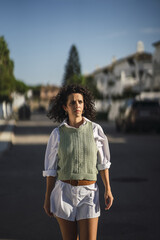 Wall Mural - Vertical shot of a Spanish female posing in the park