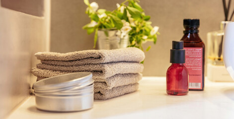 Reed diffuser in a bathroom, black sticks in a glass bottle, modern design spa interior detail..