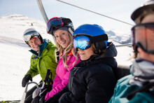 Portrait Happy Skier Family Riding Ski Lift