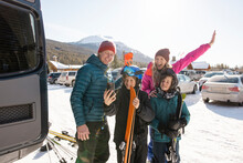 Happy Family With Skis Taking Selfie In Sunny Ski Resort Parking Lot