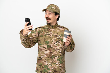 Wall Mural - Soldier man isolated on white background holding coffee to take away and a mobile