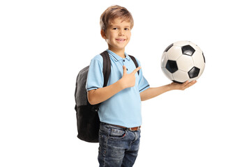 Canvas Print - Boy with a backpack holding a football and pointing