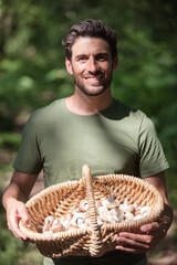 portrait of a man picking mushrooms in a forest