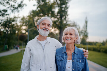 Senior family couple walking together at summer park.