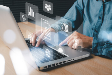 Enterprise Resource Planning ERP, document management concept with icons on virtual screen, Business woman working with laptop computer with icons on virtual screen on office desk.
