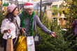 © JackF - Family couple choosing christmas tree at christmas street fair
