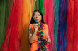 © Milou Dirks - Abstract portait of asian woman in dress blowing bubbles in front of multi color backdrop wall