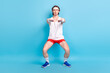 © deagreez - Full length body size photo man doing stretching wearing sportswear headband isolated pastel blue color background