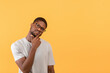 © Prostock-studio - Pensive african american man looking aside at free space and touching chin, thinking about offer over yellow background