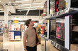 © Igor Kardasov - Man choosing TV in mall