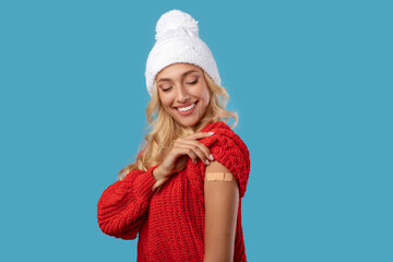 Happy Vaccinated Woman Looking At Shoulder With Adhesive Bandage