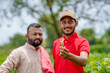 © PRASANNAPIX - Indian agronomist or officer discussing with farmer at green cotton agriculture field.