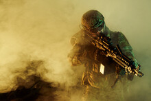 Portrait Of Airsoft Player In Professional Equipment With Machine Gun In Abandoned Ruined Building. Soldier With Weapons At War In Smoke And Fog