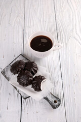 Poster - Marshmallow in chocolate and black coffee with cinnamon on a white wooden background