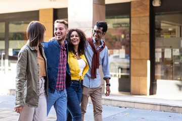 Multicultural friends walking in city center - Happy guys and girls having fun around shopping town streets - University students on travel vacations