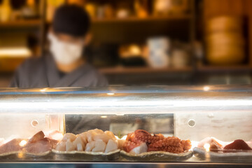 Wall Mural - Many of Sashimi fresh food as squid and fish in showcase at the bar counter