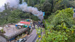 himalayan toy train with smoke at mountain from top angle