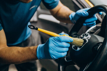 Man cleaning car details with brush