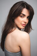 © pridneprovskiy - Girl without makeup in a gray top on a light background