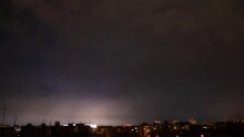 Timelapse - Dark Stormy Sky With Lightning Strikes And Fast Moving Thunderstorm Clouds Over City At Night. Dramatic, Nature, Danger, Weather, Time Lapse Concept