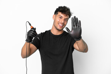 Wall Mural - Tattoo artist caucasian man isolated on white background saluting with hand with happy expression