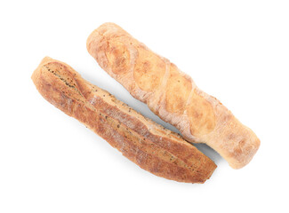 Different tasty baguettes on white background, top view. Fresh bread