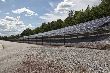 Ground view Rows of Solar panels behind a fence