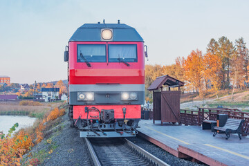 Wall Mural - Highspeed train stands by the wooden platform at sunset. Sortavala. Republic of Karelia.