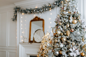 Beautiful Christmas tree with festive gold, white decor against blurred lights on background, closeup. Christmas and New Year concept. 