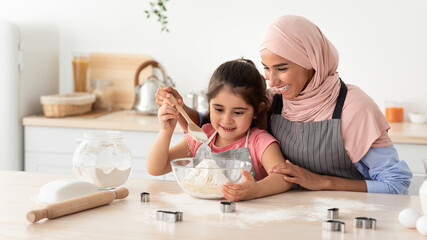 Wall Mural - Baking At Home. Muslim Woman And Little Daughter Making Dough For Cookies