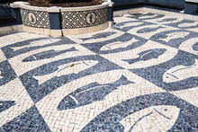 Pavement Representing Fish And Wall Covered With Azulejos In The Old Town Of Faro, Algarve, Portugal