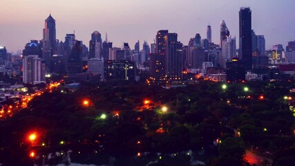 Wall Mural - Day and night transition time lapse of cityscape and buildings in metropolis . Downtown city center business district in panoramic view .