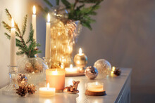 Christmas Decorations With Burning Candles In White Room
