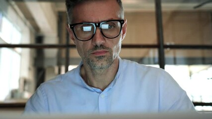 Wall Mural - mature concentrated business man trader wearing eyeglasses working looking at laptop computer screen