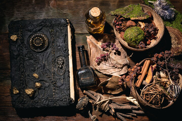 Wall Mural - Concept of magic book, dry herb and magic potion on the wooden table background.