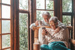 © Daniel - Couple of two old and mature people at home using phone together in sofa. Senior use smartphone having fun and enjoying looking at it. Leisure and free time concept in the living room.