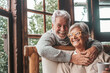 © Daniel - Portrait of couple of two happy and healthy seniors old people smiling and looking at the camera. Close up of mature grandparents enjoying and having fun together at home indoor..