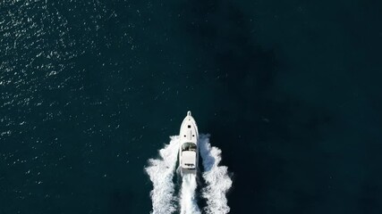 Wall Mural - White Yacht roaring across blue ocean water, Aerial chase.