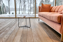 Close-up Of Natural Wood Parquet Floor In Living Room In Country House With Table And Sofa