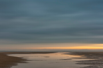 Wall Mural - beautiful sunrise landscape image of talacre beach at surnise with dramatic sky and clouds