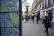 London Street Map with focus on the foreground and people on the street walking out of focus in the background
