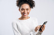 © speed300 - Portrait of overjoyed multiracial woman holding smartphone at her hands and looking at the camera. Technologies concept