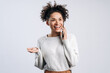 © speed300 - Waist up body size view of lovely focused cheerful girl wearing knitted sweater using gadget and having pleasure conversation isolated over white color background