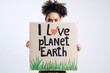 © speed300 - Multiracial brunette curly woman holding carton placard with I love planet earth and hiding her face behind it. Concept of eco activism