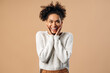 © speed300 - Wow, unbelievable. Portrait of excited amazed multiracial woman touching face and smiling in surprise, shocked by unexpected win, crazy news. Indoor studio shot isolated on beige background